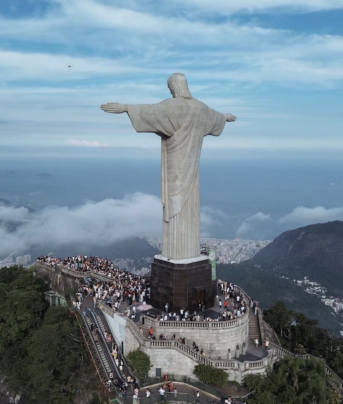 Tourists exploring the viewing platform and surroundings at Corcovado Mountain summit
